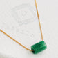 A natural green jade bead necklace with a polished finish, strung on a gold-plated sterling silver chain, offering a minimalist and elegant style.