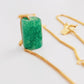 A natural green jade bead necklace with a polished finish, strung on a gold-plated sterling silver chain, offering a minimalist and elegant style.