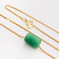 A natural green jade bead necklace with a polished finish, strung on a gold-plated sterling silver chain, offering a minimalist and elegant style.