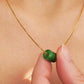 A natural green jade bead necklace with a polished finish, strung on a gold-plated sterling silver chain, offering a minimalist and elegant style.