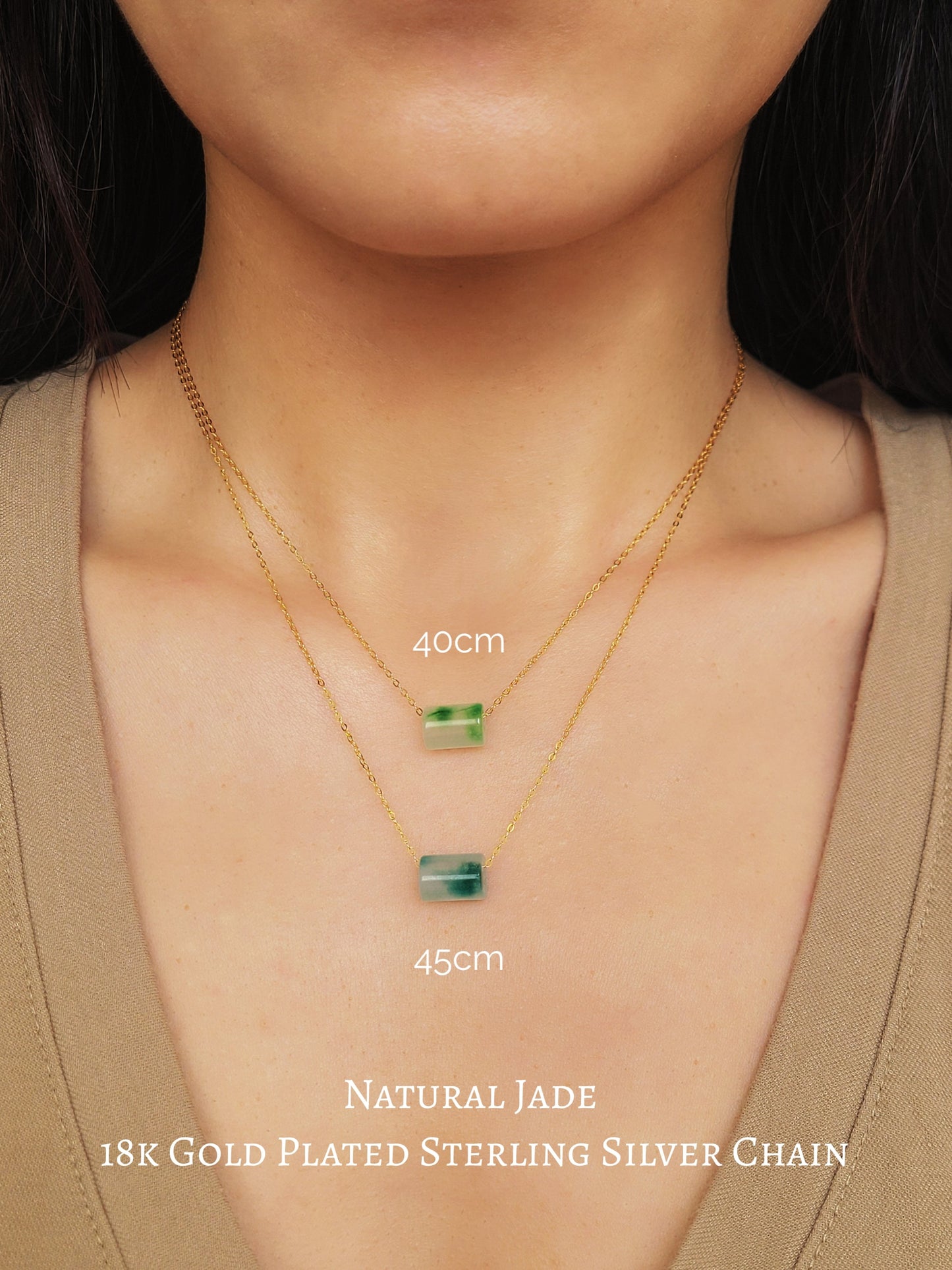 A close-up of a pair of natural jade charm necklace, featuring an icy green jade or icy blue jade pendant on a gold-plated sterling silver chain, showcasing a delicate and elegant look.