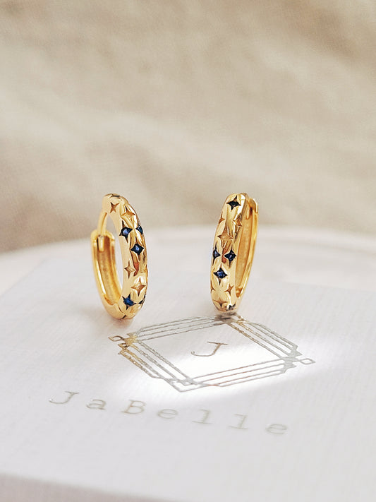 Dainty Sapphire Blue Star Huggie Earrings, crafted in gold plated sterling silver. Perfect for everyday wear, ideal gift for anniversaries and birthdays.
