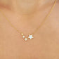 A woman wearing the Stars Pendant Necklace with 4 little stars.