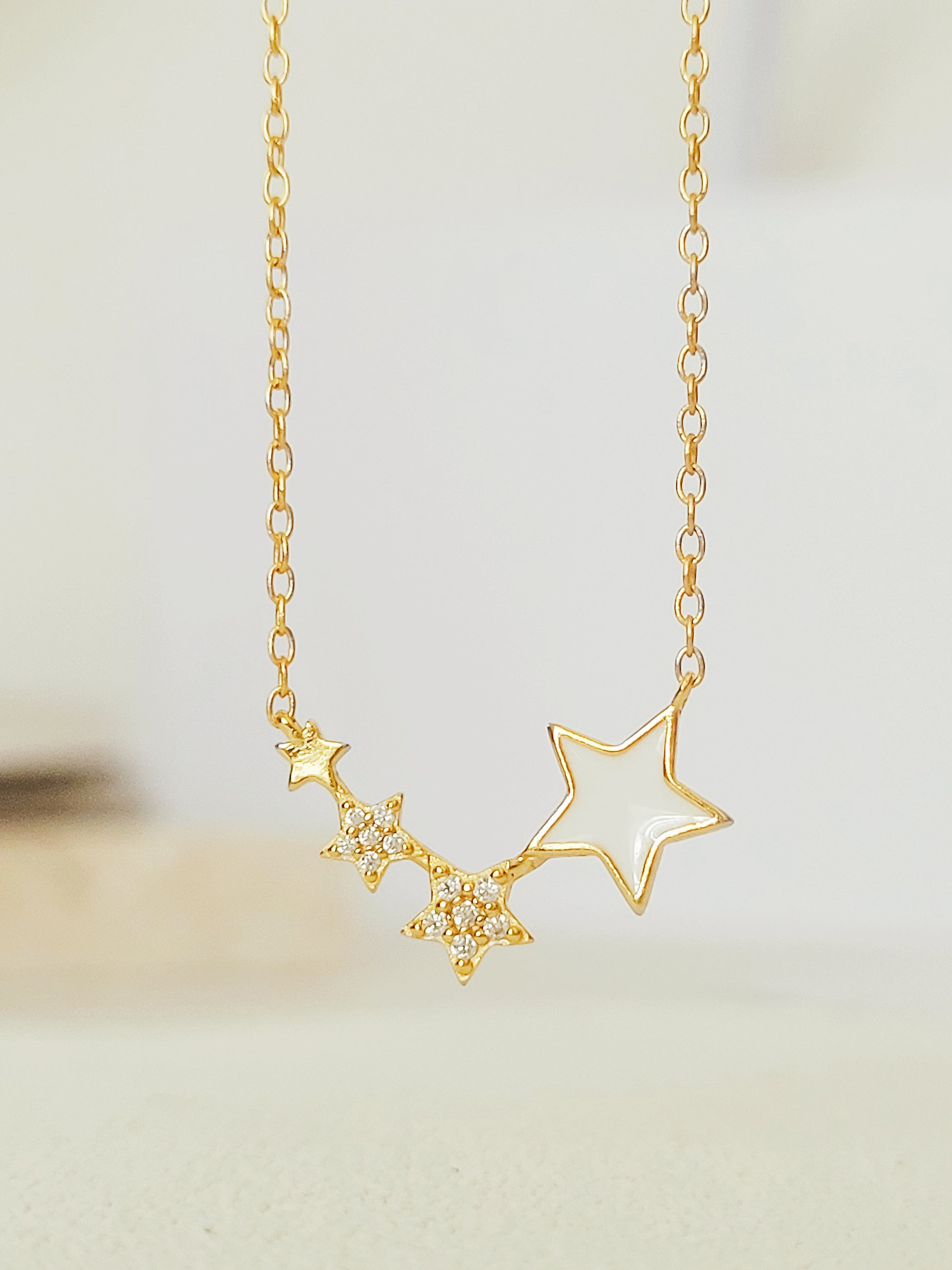 Close-up of the Stars Pendant Necklace showcasing the detailed craftmanship. 