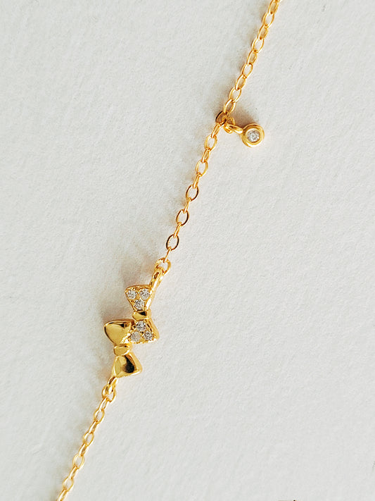 A lovely double bows bracelet with two charming bows, designed to elevate your look with a touch of whimsy and elegance.