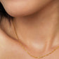 Close up of a woman wearing a minimalist gold chain necklace