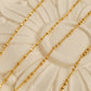 Stylish gold plated sterling silver chain necklace displayed on a white surface