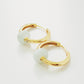 Elegant gold hoop earrings adorned with exquisite pale green jade natural stones, embodying timeless luxury and sophistication.