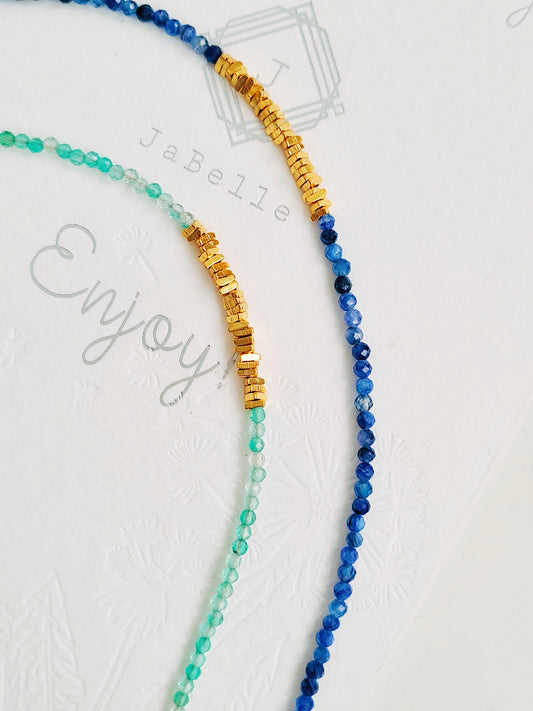 Beaded green onyx choker necklace and kyanite gemstone necklace with 22k gold vermeil accents displayed on white background.