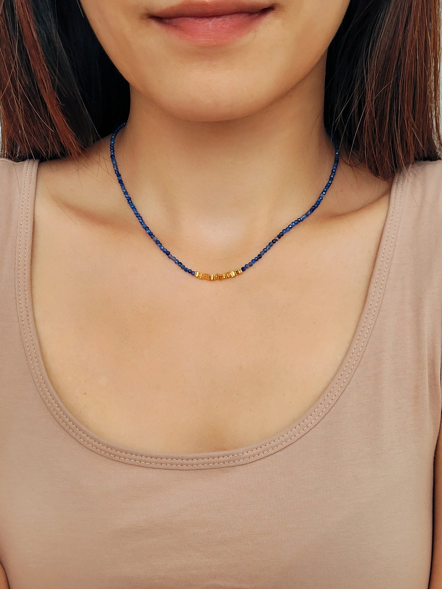 A woman wearing kyanite beaded gemstone choker necklace with gold vermeil accents, showing casing minimalist and elegant style. Perfect gift for her.