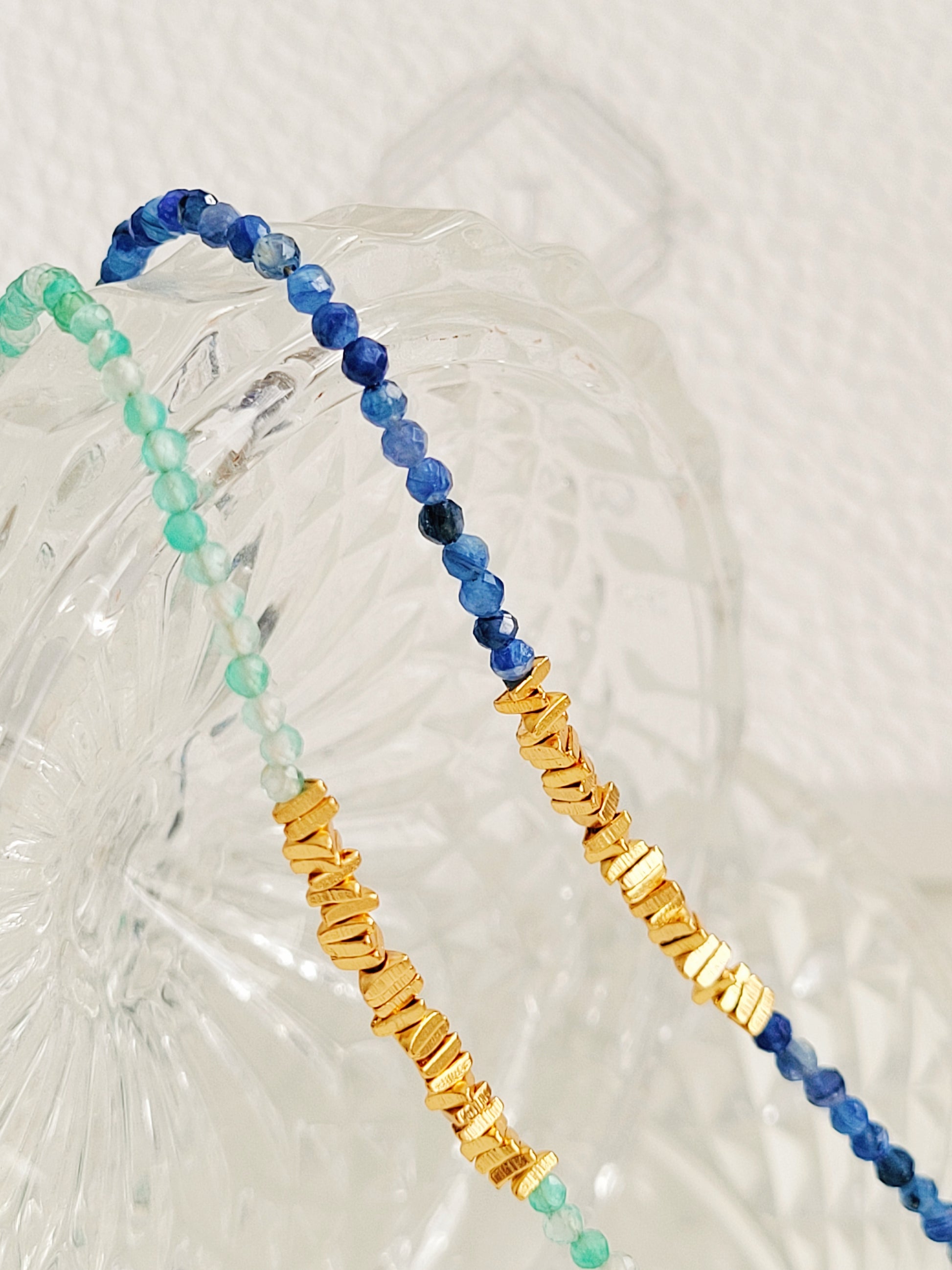 Close-up of kyanite beaded choker necklace with gold accents and handmade dainty gold choker with natural green onyx beads and gold nuggets.