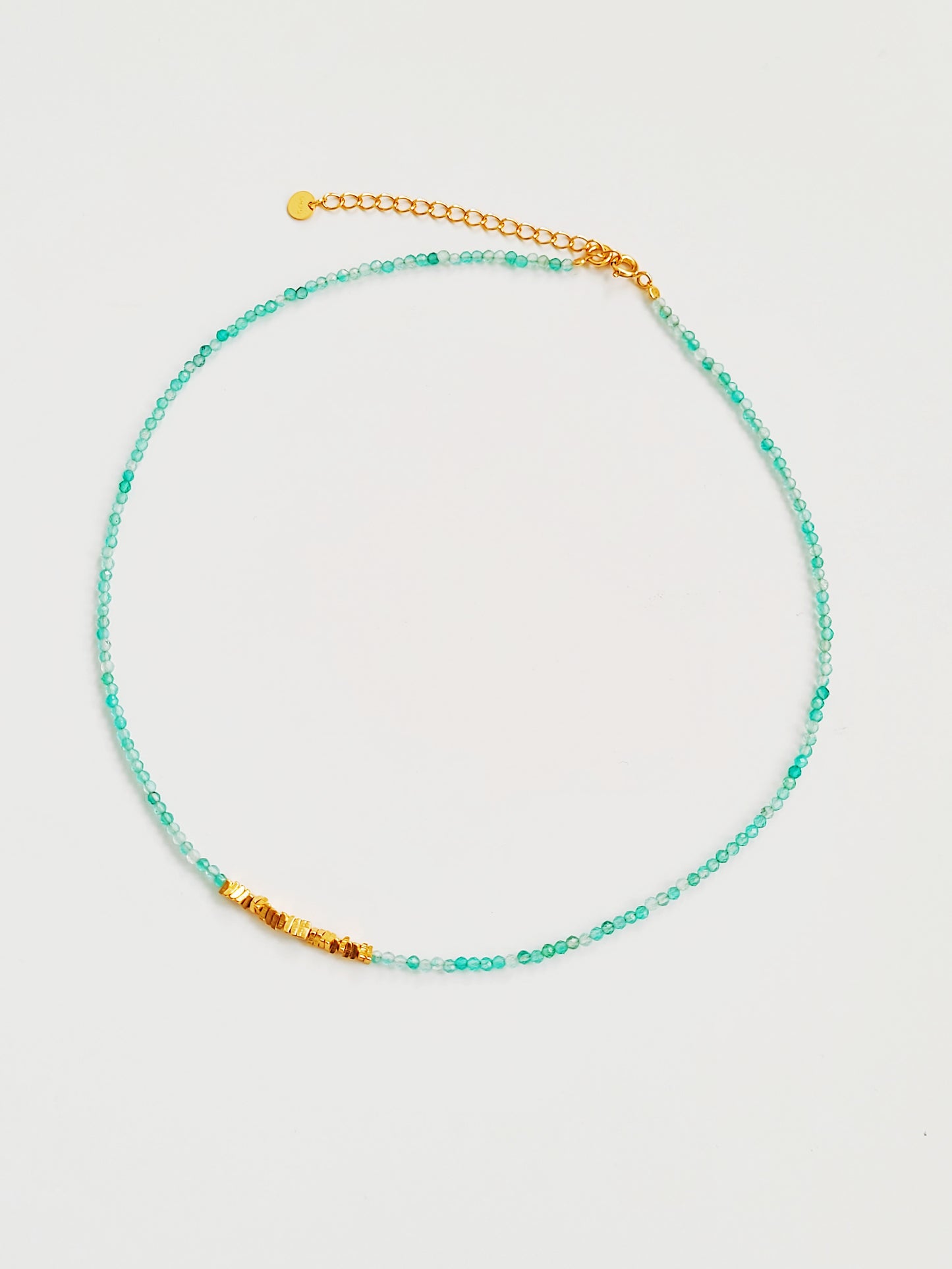 Close-up of kyanite beaded choker necklace with gold accents and handmade dainty gold choker with natural green onyx beads and gold nuggets.