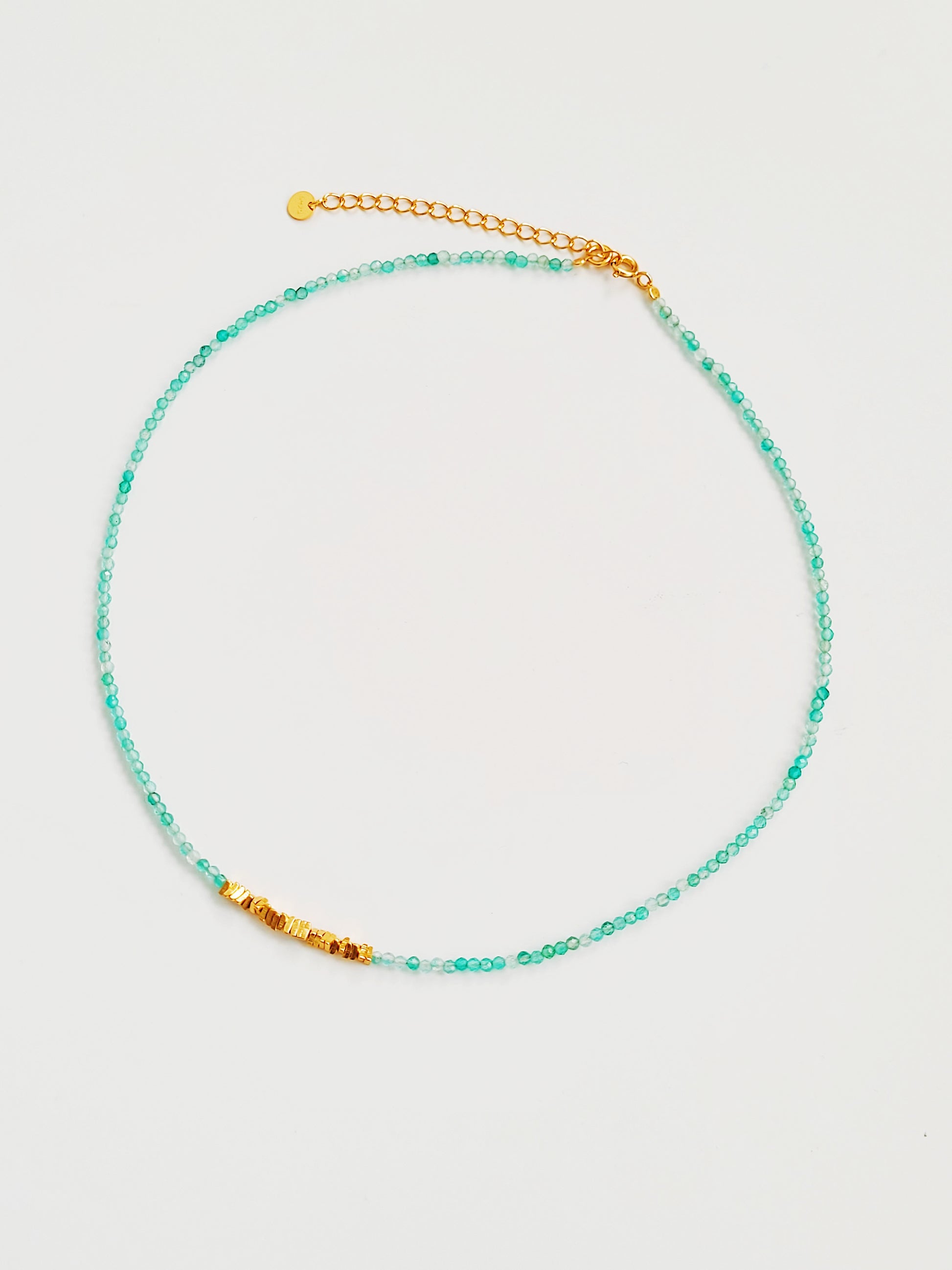 Close-up of kyanite beaded choker necklace with gold accents and handmade dainty gold choker with natural green onyx beads and gold nuggets.