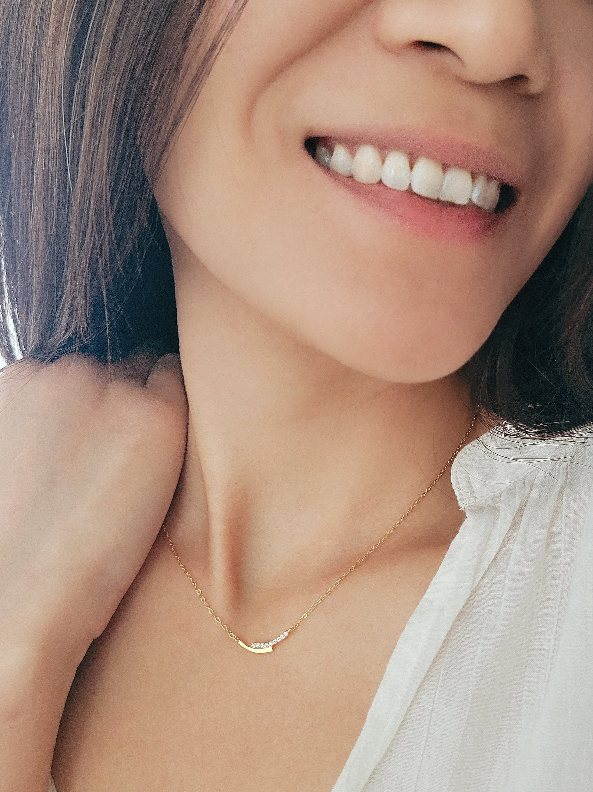 A girl wearing a gold bar necklace in gold plated sterling silver, best gift for her