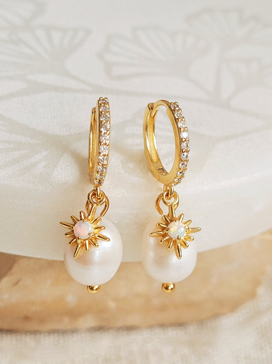 Elegant pearl drop earrings featuring a gold opal star charm, crafted in gold plated sterling silver. Perfect bridal or everyday earrings with celestial charm and timeless sophistication. Anniversary gift for her.