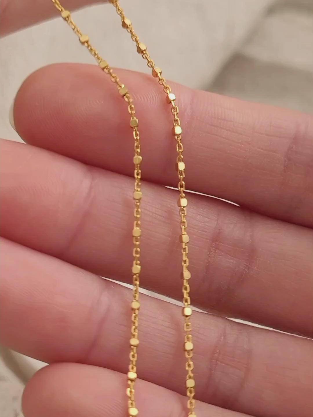 close up of a square beaded gold chain necklace, dainty and delicate, unique style everyday jewellery for women