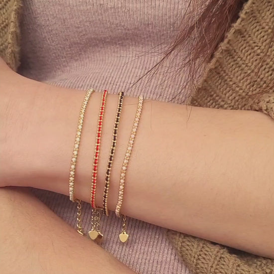Gold-plated sterling silver string bracelets in Black, Blue, Red and Pink, perfect as friendship bracelets or meaningful graduation gifts for everyday wear.