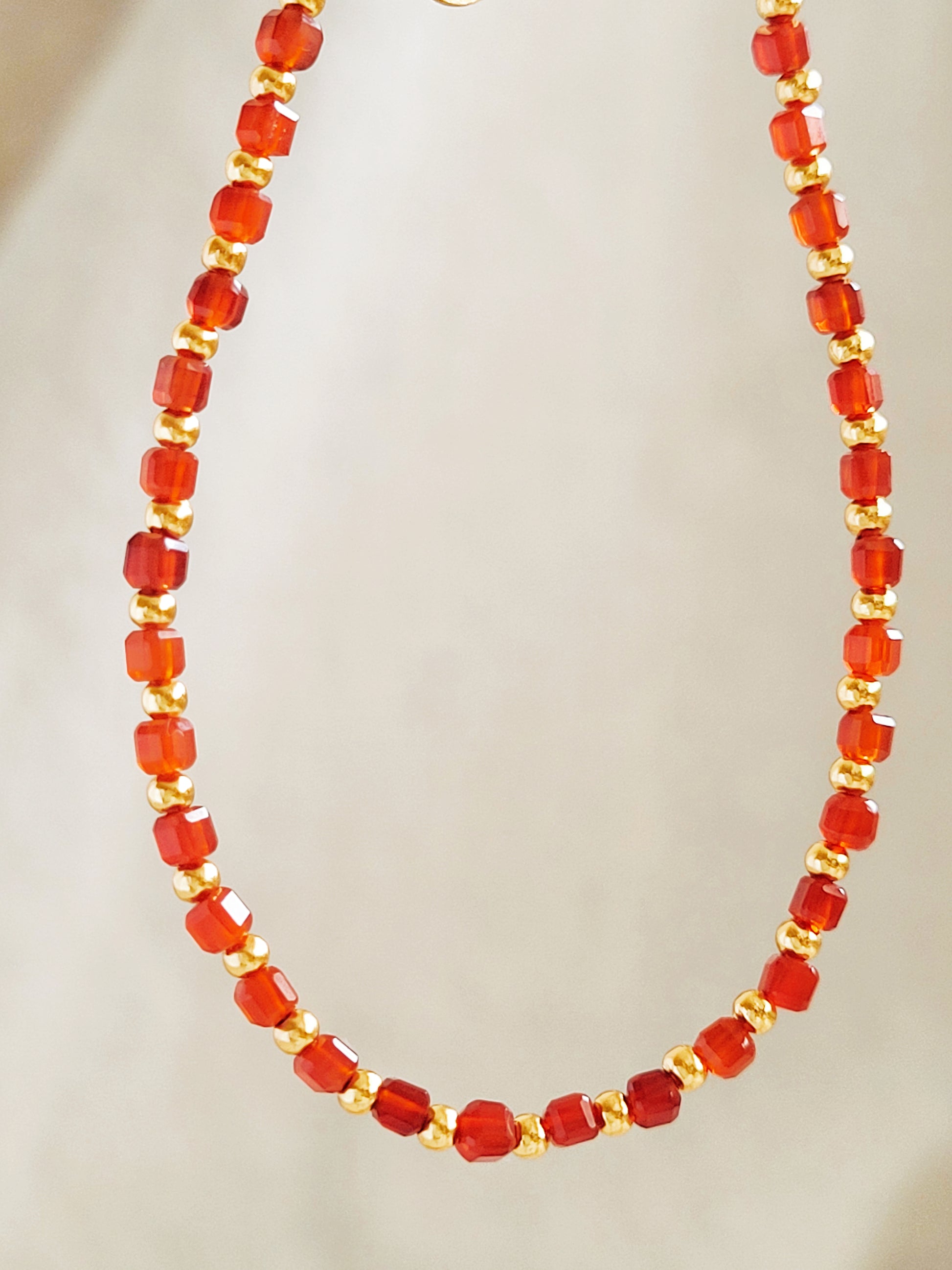 Delicate handcrafted bracelet with cube red onyx beads and gold accents